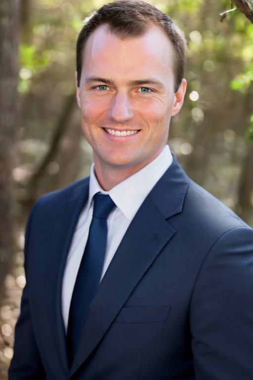 Professional headshot of Craig, founder of Money on the Mend, in a navy suit outdoors