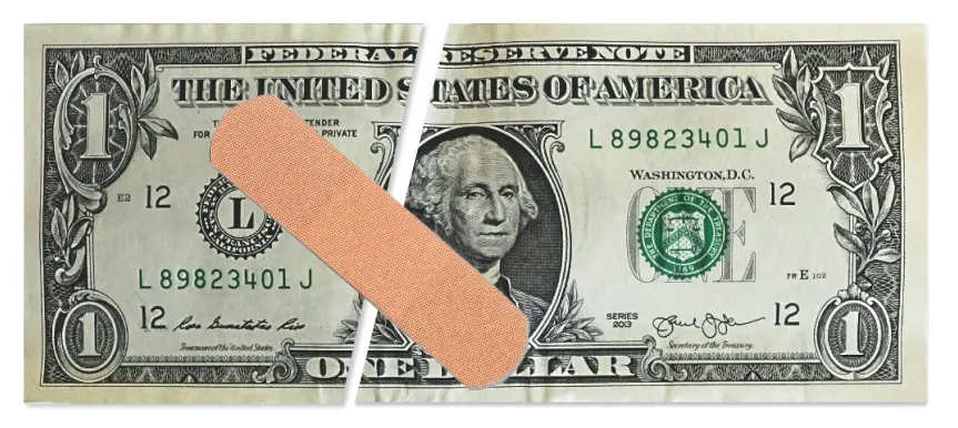 A US one-dollar bill torn in half and mended with a large adhesive bandage, representing financial recovery — Money on the Mend